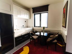 a kitchen with a table and chairs and a sink at Mercure Baku City in Baku