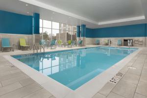 a large swimming pool in a hotel room at Hampton Inn & Suites Durham University Medical Center in Durham