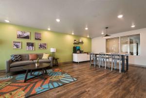 a living room with a couch and a table at WoodSpring Suites Rockledge - Cocoa Beach in Rockledge