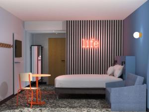 a bedroom with a bed and a sign that reads life at greet Hotel Paris 13 Porte d'Italie in Le Kremlin-Bicêtre