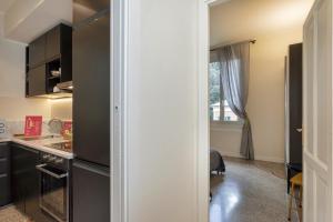 a kitchen with a black refrigerator and a sink at Classy Apartment in Portofino by Wonderful Italy in Portofino