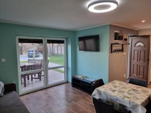 a living room with a bed and a sliding glass door at Habitat of Dreams in Makó