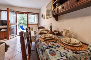 a dining room with a table with plates on it at APT. Planibel in La Thuile