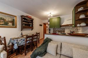a living room with a table and a kitchen at APT PLANIBEL - Comfort sulle piste da SCI - LA THUILE 0086 in La Thuile +17 photos