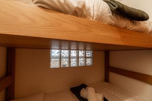 a bedroom with two bunk beds with a window at APT. Planibel in La Thuile