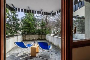 two blue chairs sitting on a patio with a table at APT PLANIBEL - Comfort sulle piste da SCI - LA THUILE 0086 in La Thuile