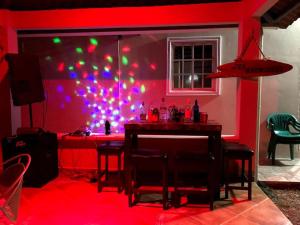 a red room with a table with chairs and lights at Vacations House in Penonomé, Cocle in Penonomé