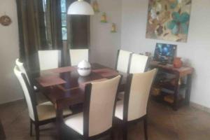 a dining room with a wooden table and chairs at Vacations House in Penonomé, Cocle in Penonomé