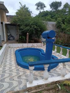 uma piscina azul de água num quintal em Chácara das Pedras em Taubaté