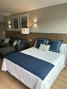 a bedroom with a large bed and a couch at Top Balea in Pontevedra