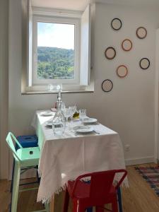 a table with a white table cloth and a window at Casa Alta in Castelo de Vide