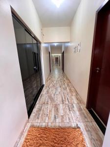 a long hallway with a floor of tiles at Pousada Panela De Ferro in Mateiros