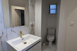 a white bathroom with a sink and a toilet at Cosy Queen - T4 - Hyper centre & parking in Pau +28 photos