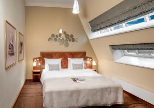 a bedroom with a large bed in a room at Crown Palace Apartments by Adrez in Prague
