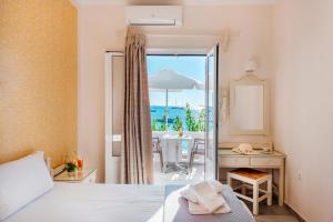 sypialnia z łóżkiem i widokiem na ocean w obiekcie Irene Hotel - Beachfront w mieście Parikia
