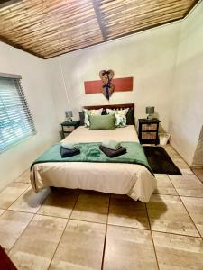 a bedroom with a large bed in a room at Kranskloof Country Lodge in Oudtshoorn