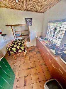 a kitchen with a table and a bench in a room at Kranskloof Country Lodge in Oudtshoorn