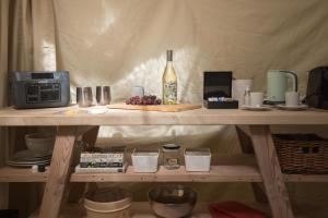 a table with a bottle of wine and a plate of fruit at Stay Wilder Sunshine Coast in Sechelt