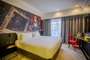 a hotel room with a large bed and a desk at SO City Hotel Adults Only in St. Julianʼs