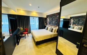 a hotel room with a bed and a desk and a room at SO City Hotel Adults Only in St. Julianʼs