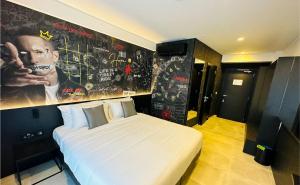 a bedroom with a bed and a poster of a man at SO City Hotel Adults Only in St. Julianʼs