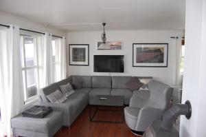 a living room with a couch and a tv at Feriehus nede ved sjøen inntil 6 pers in Vestnes