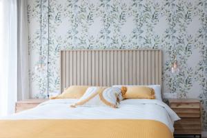 a bedroom with a bed and a wall with wallpaper at DormForYou Arena Delux terraza in Valencia