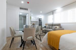 a bedroom with a bed and a table and chairs at DormForYou Arena Standard in Valencia