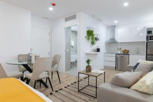 a living room and kitchen with a couch and a table at DormForYou Arena Standard in Valencia