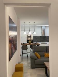 a living room and kitchen with a couch and a table at WISH SUITE PONCE DE LEON in Seville