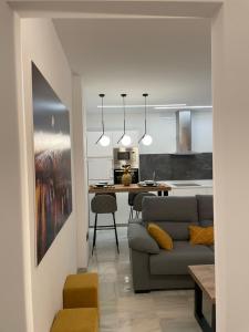a living room with a couch and a table at WISH SUITE PONCE DE LEON in Seville +55 photos
