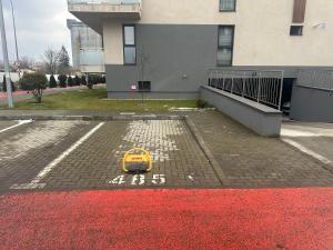 a yellow toy car on a brick road with red paint at The Cozy One in Târgu-Mureş