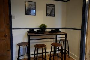 a small table with stools in a room at Centrally Located Stylish Flat in Jesmond