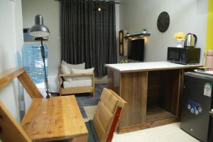 a kitchen with a counter and a table and a microwave at ENz Lovely Apartment 8 in Bungoma