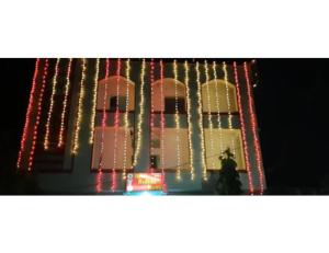 a building with christmas lights on the side of it at Hotel Radhika Kunj Palace, Chhatarpur in Chhatarpur