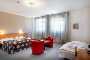 En eller flere senger på et rom på Hotel Galant Mikulov