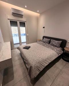 a bedroom with a bed and a air conditioner on the wall at Central Stylish Lux Apartments in Lamía