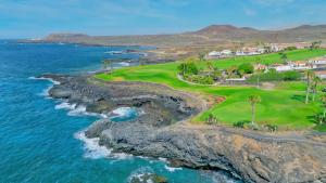 an aerial view of a golf course next to the ocean at Amarilla Golf Suite by VV Canary Ocean Homes in San Miguel de Abona