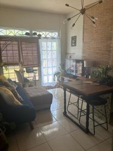 a living room with a table and a couch at MI CASITA BOHO GREEN in Guayama