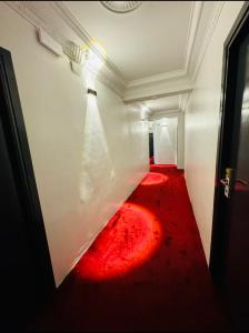 a hallway with a red carpet on the floor at Crystal boulevard in Tangier