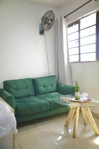 un divano verde in un soggiorno con tavolo di Eagle Nest furnished studio apartments at Eagle Tower. a Nairobi