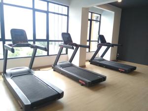 a group of treadmills in a gym with a window at Sann's Lodge in Putrajaya