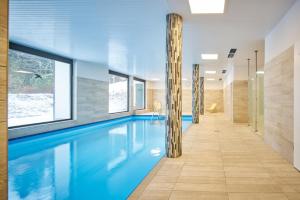 a swimming pool in a bathroom with a large window at Winterberg Appartement 21097 in Winterberg
