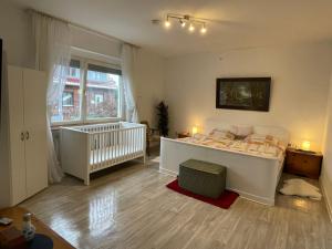 a bedroom with a bed and a crib in it at RobinsHomes-Weddel in Cremlingen