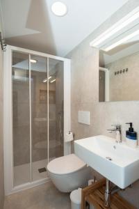 a bathroom with a white sink and a shower at Alibi B11 in Piran