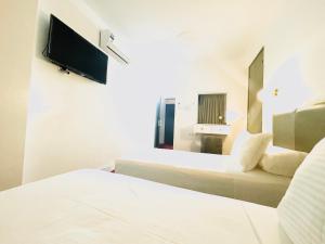 a hotel room with two beds and a flat screen tv at Crystal boulevard in Tangier