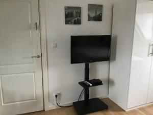 a flat screen tv on a stand in a room at Sunny dunes in Zandvoort