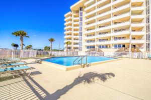 a swimming pool in front of a large apartment building at Perdido Sun Resort 704 By Pkrm in Pensacola