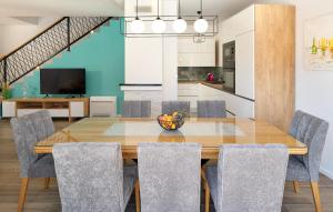 a dining room with a wooden table and chairs at Stunning Home In Sestanovac in Šestanovac