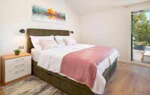 a bedroom with a large bed and a window at Stunning Home In Sestanovac in Šestanovac +25 photos
